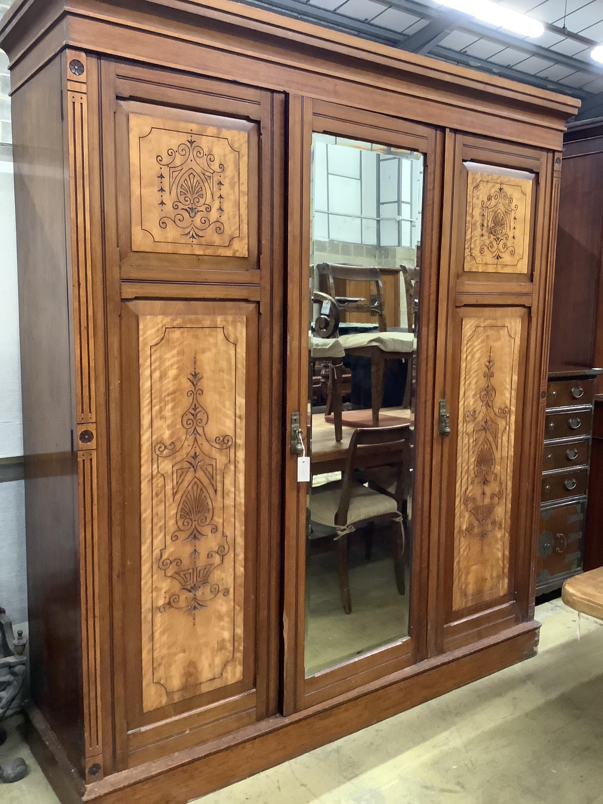 A late Victorian aesthetic movement mahogany and satin birch compactum wardrobe, width 186cm, depth 56cm, height 211cm